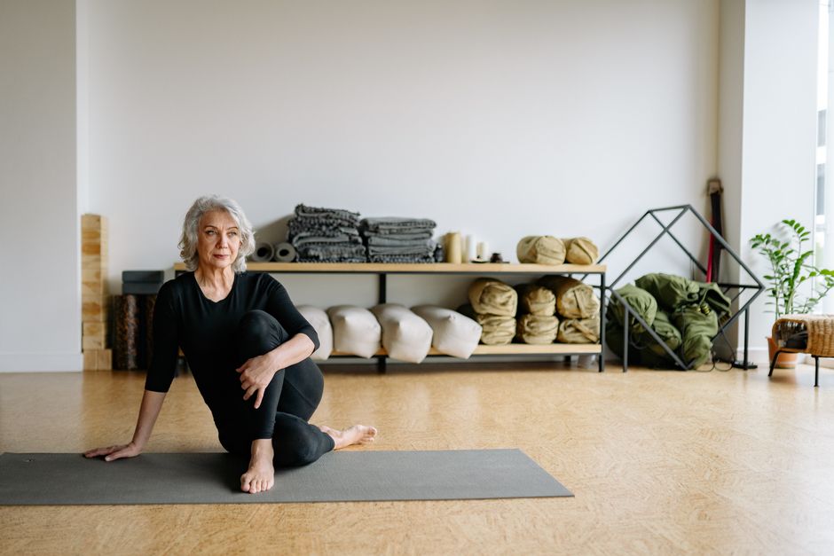 Student resting in a supported yin yoga pose